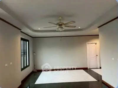 Spacious living room with elegant ceiling fan and modern design