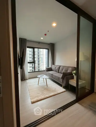 Modern living room with cozy sofa and city view, perfect for urban living.