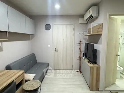 Modern compact living room with sleek furniture and air conditioning