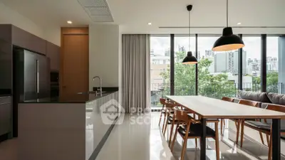 Modern kitchen and dining area with city view and sleek design.