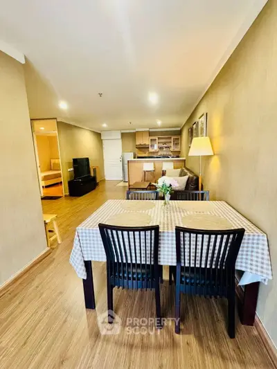 Spacious open-plan living and dining area with modern furnishings and warm lighting.