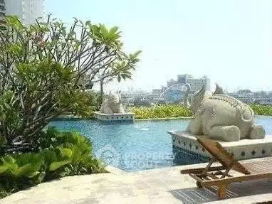 Luxurious rooftop pool with stunning city views and elegant sculptures, perfect for relaxation and leisure.