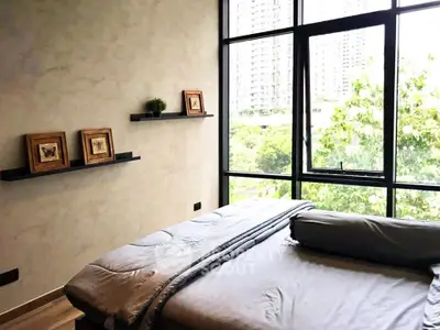 Modern bedroom with large windows offering a lush green view, minimalistic decor, and cozy bedding.