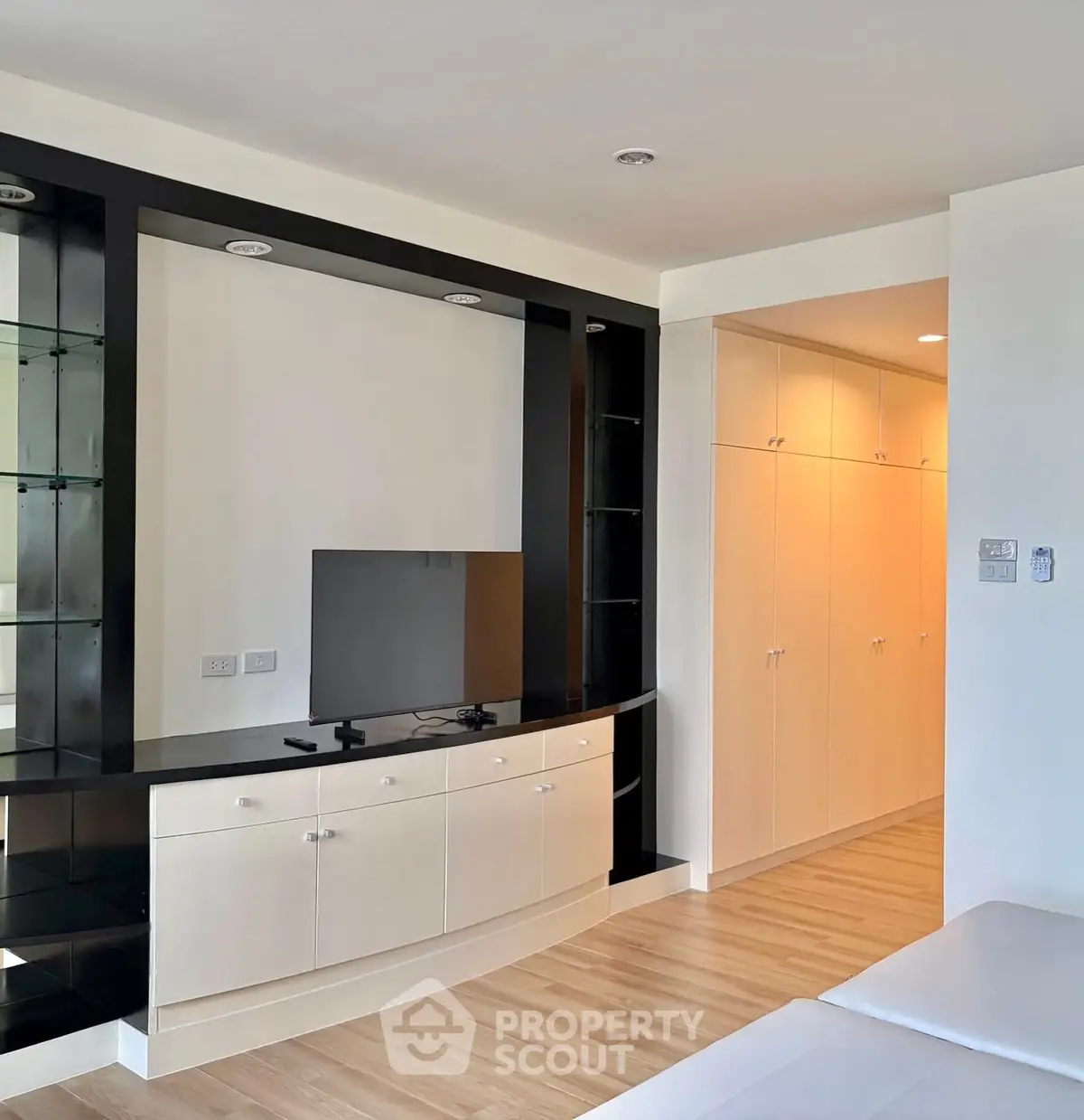 Modern living room with sleek built-in entertainment unit and ample storage space.