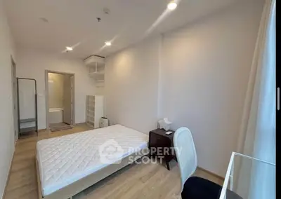 Spacious bedroom with minimalist decor and natural light