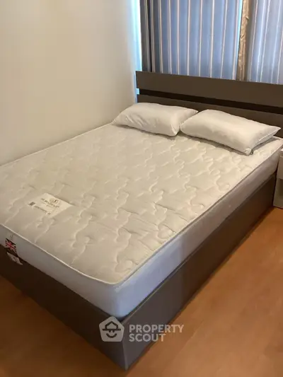 Modern bedroom with sleek bed frame and comfortable mattress, perfect for restful nights.