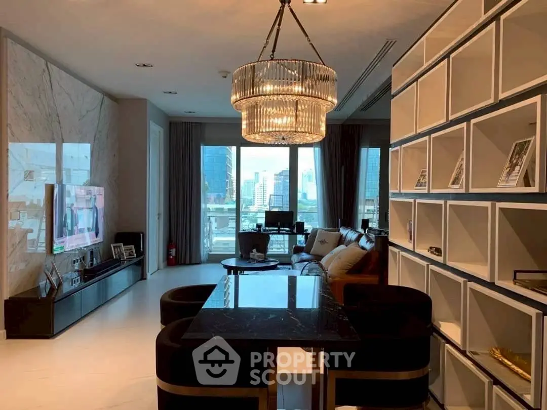 Luxurious living room with elegant chandelier and city view, featuring modern decor and spacious layout.