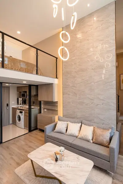 Modern loft apartment with stylish living room and mezzanine, featuring elegant lighting and contemporary decor.