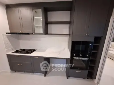 Modern kitchen with sleek cabinetry and built-in appliances, featuring a gas stove and oven.