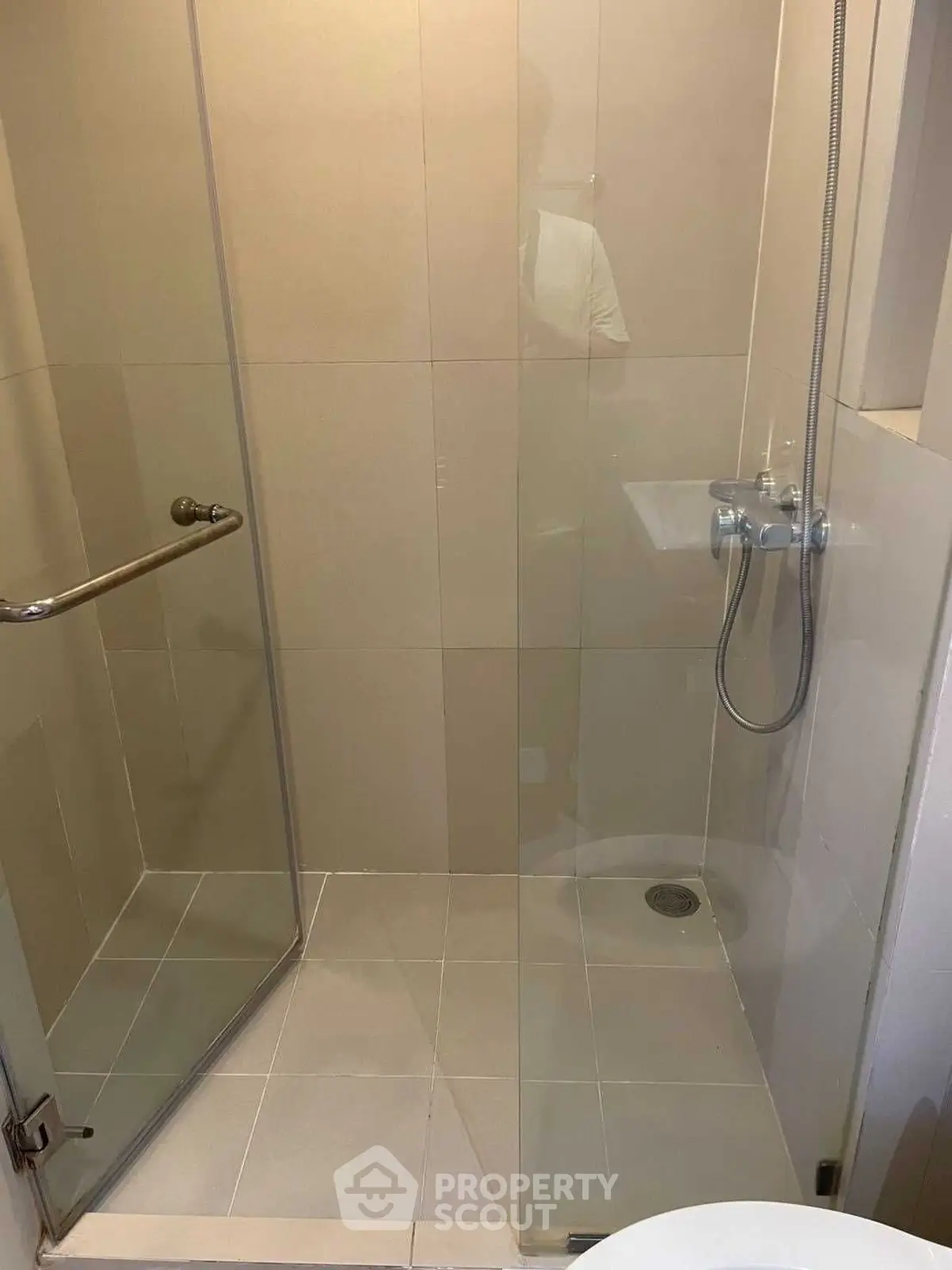 Modern bathroom with glass shower enclosure and sleek fixtures