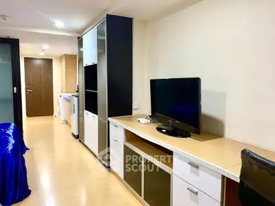Modern apartment interior with sleek furniture and built-in storage solutions.