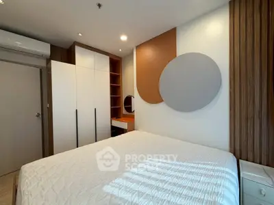 Modern bedroom with stylish decor and ample storage space