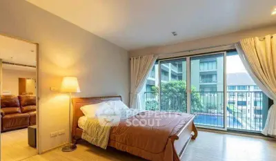 Spacious bedroom with balcony view in modern apartment