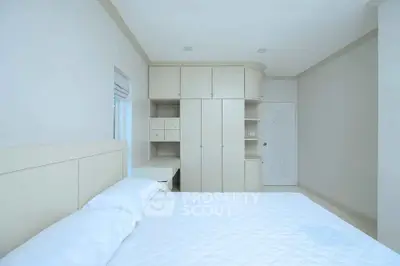 Spacious bedroom with built-in wardrobe and minimalist design
