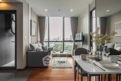 Modern living room with city view, elegant decor, and cozy seating area.