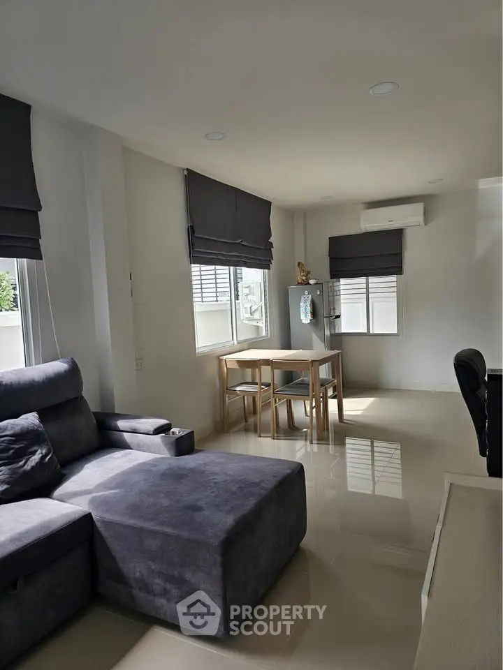 Modern living room with sleek furniture and natural light, perfect for relaxation and entertaining.