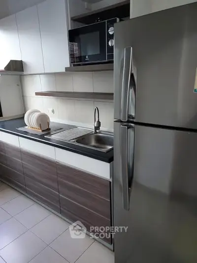 Modern kitchen with sleek cabinets and stainless steel fridge