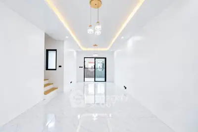 Spacious modern living room with elegant lighting and glossy white flooring