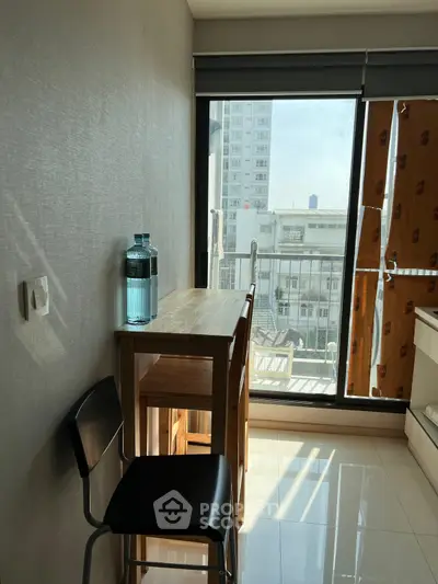 Cozy dining nook with natural light and city view, perfect for intimate meals.