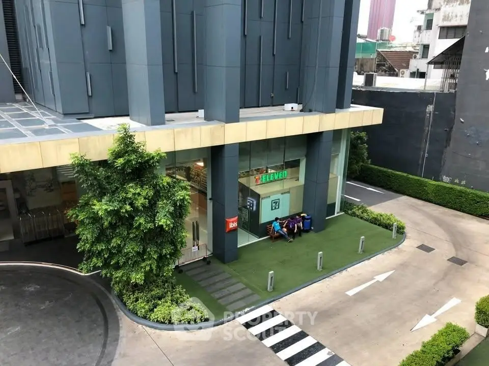 Modern building exterior with convenience store and landscaped entrance