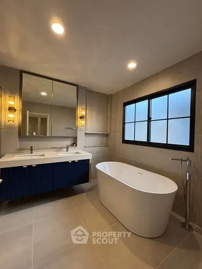 Luxurious modern bathroom with freestanding bathtub and elegant lighting