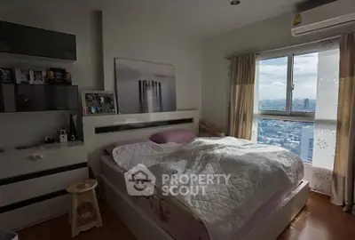 Cozy bedroom with city view and modern decor, perfect for urban living.