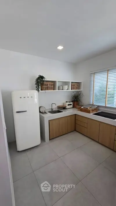 Modern kitchen with SMEG fridge and minimalist design