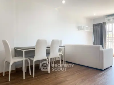 Spacious modern living room with white furniture and wooden flooring