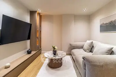 Cozy modern living room with plush sofa and wall-mounted TV