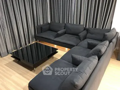 Modern living room with sleek black sofa and stylish coffee table