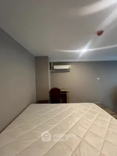 Spacious bedroom with air conditioning and modern decor, perfect for comfortable living.