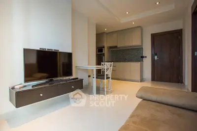 Modern living room with sleek kitchen and cozy seating area