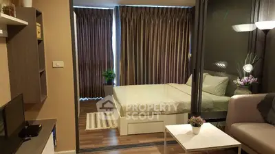 Modern studio apartment with cozy bedroom and stylish living area, featuring elegant decor and natural light.