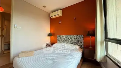 Cozy bedroom with stylish decor and natural light, featuring a comfortable bed and modern lighting.