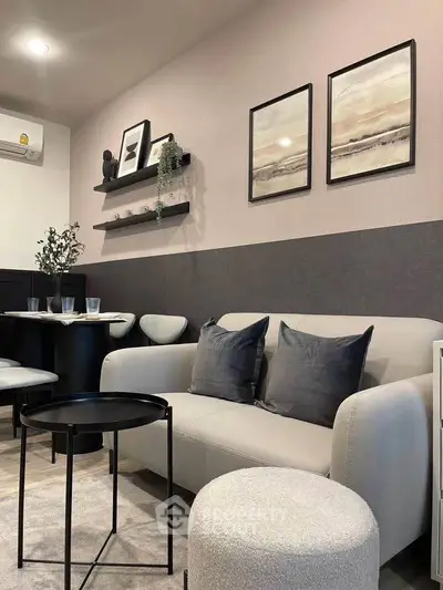 Modern living room with stylish decor, cozy sofa, and elegant wall art in a contemporary apartment.