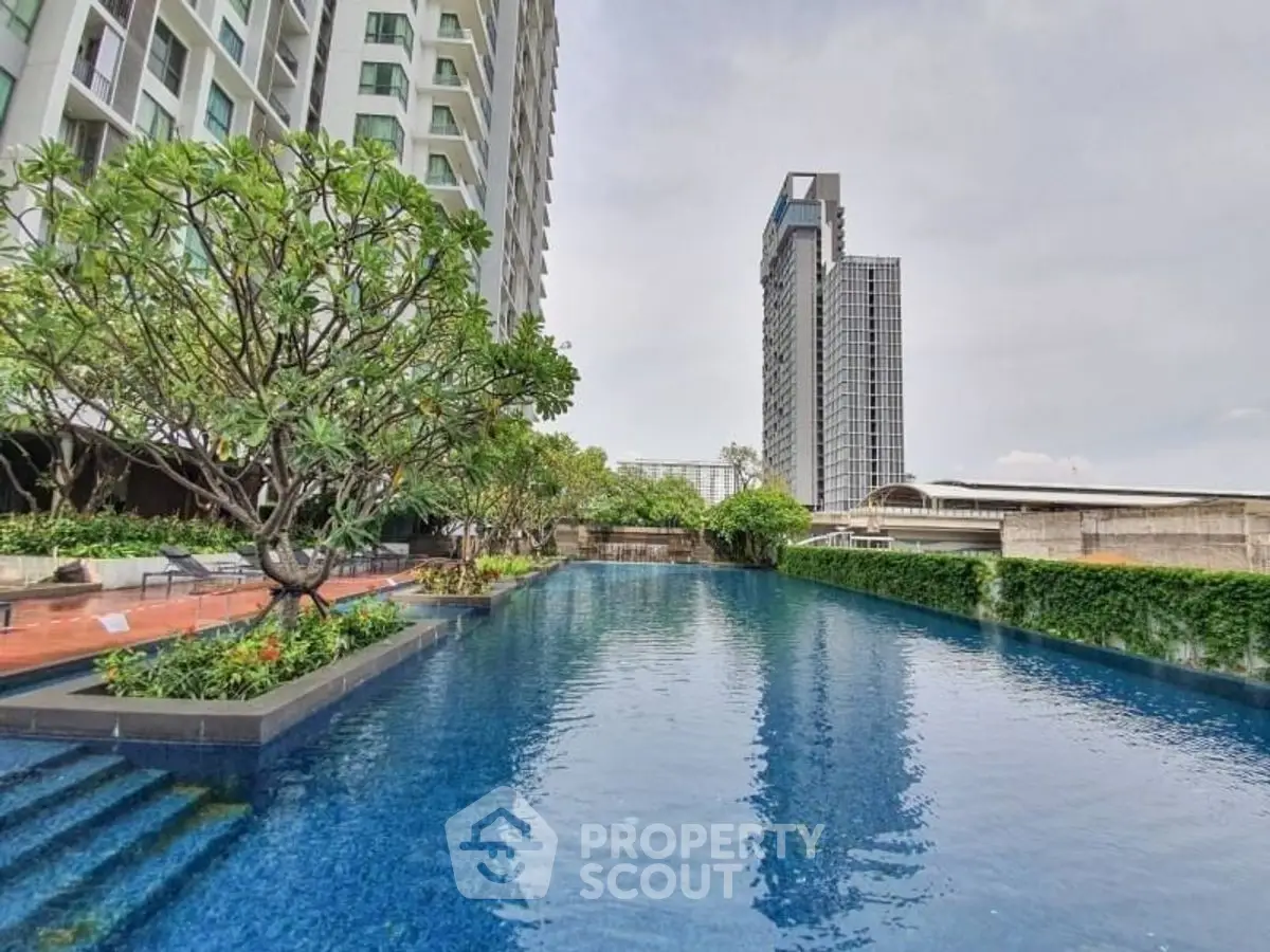 Luxurious high-rise apartment with stunning pool and lush greenery