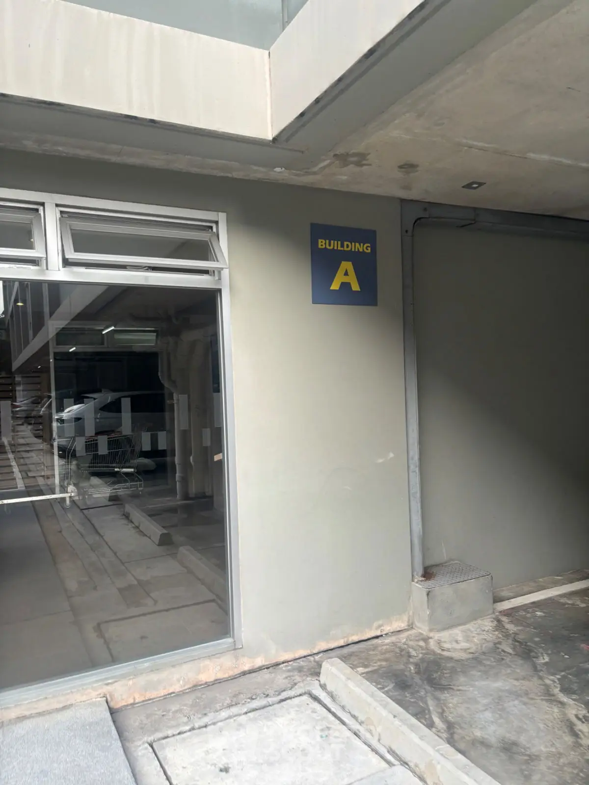 Entrance to Building A with modern design and glass doors, ideal for commercial or residential use.