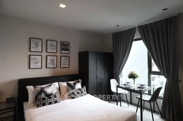 Modern bedroom with stylish decor and natural light, perfect for urban living.