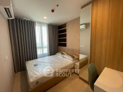 Modern bedroom with large window and stylish wooden furniture