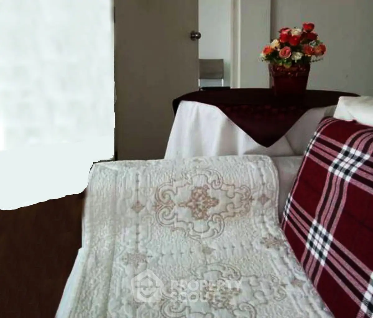 Cozy living room with plaid sofa and floral centerpiece, perfect for relaxation.