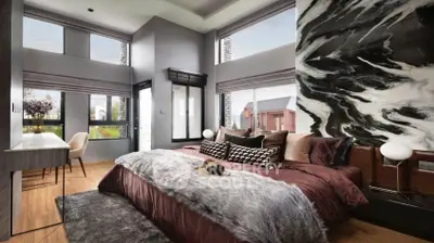 Luxurious bedroom with modern decor and large windows offering stunning views.