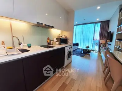 Modern open-layout kitchen with sleek appliances and cozy living area