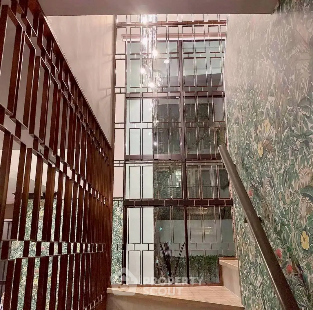 Elegant staircase with modern design and decorative wall in luxury building