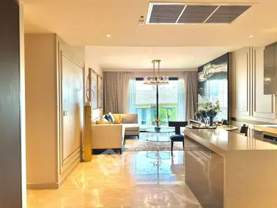 Luxurious open-plan living room with elegant decor and abundant natural light.