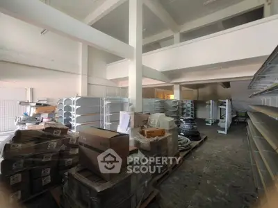 Spacious commercial warehouse with high ceilings and ample shelving space.