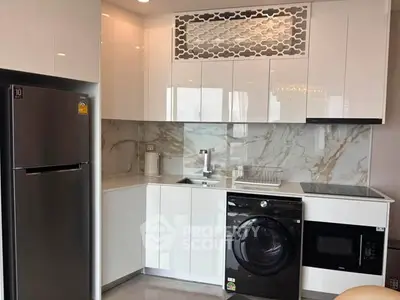 Modern kitchen with sleek white cabinets, marble backsplash, and stainless steel appliances.