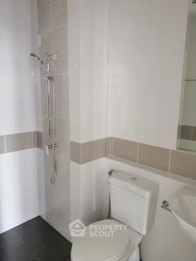 Modern bathroom with sleek shower and toilet in neutral tones