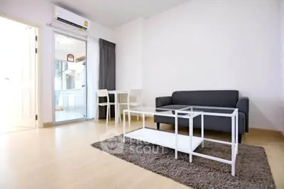 Modern living room with sleek furniture and natural light, featuring a cozy sofa and stylish coffee table.