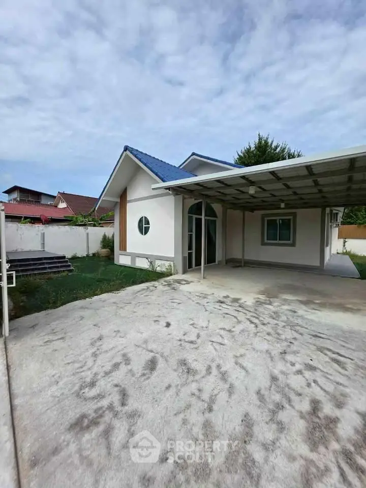 Charming single-story home with carport and spacious driveway in a serene neighborhood.