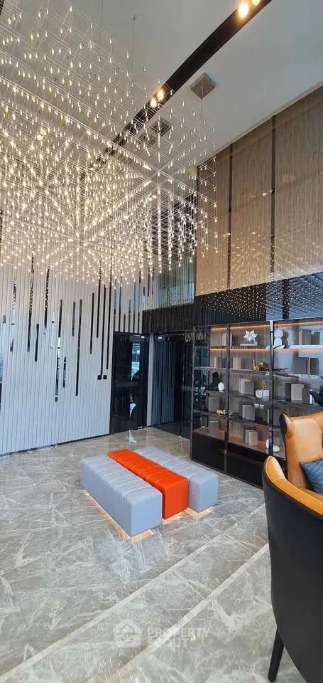 Luxurious modern lobby with stunning chandelier and elegant seating area